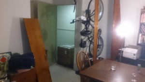 The temporary apartment of a Seattle sailor: Taylors stove in the doorway, door to the head on the left, wall to he head on the right, a bicycle hanging in the middle and a Subaru wagon parked out front.