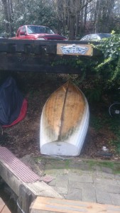 Our dinghy, unscrubbed and stored under the abandoned railway tracks that run along lake union.